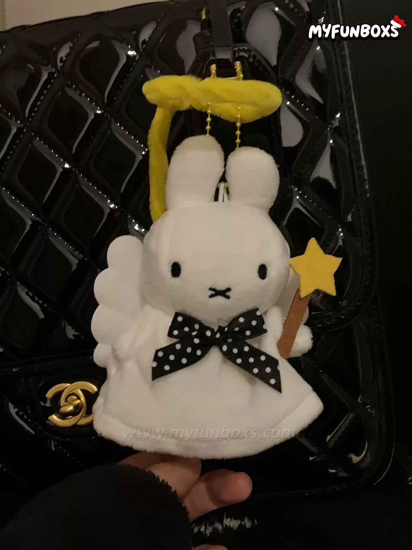 Myfunboxs Angel Miffy bag charm with yellow halo, black polka dot bow, holding star wand on glossy black handbag