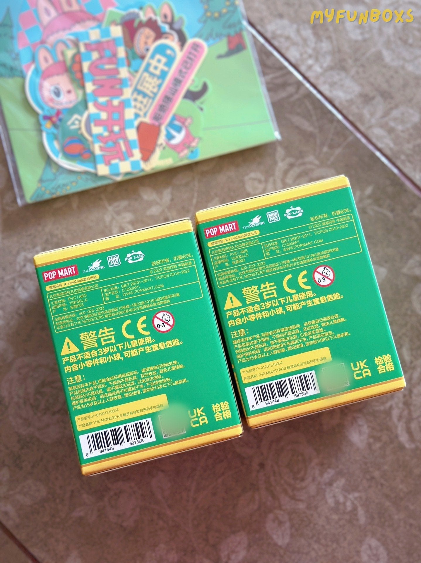 Two Labubu Elf Forest Party blind box backsides with safety warnings